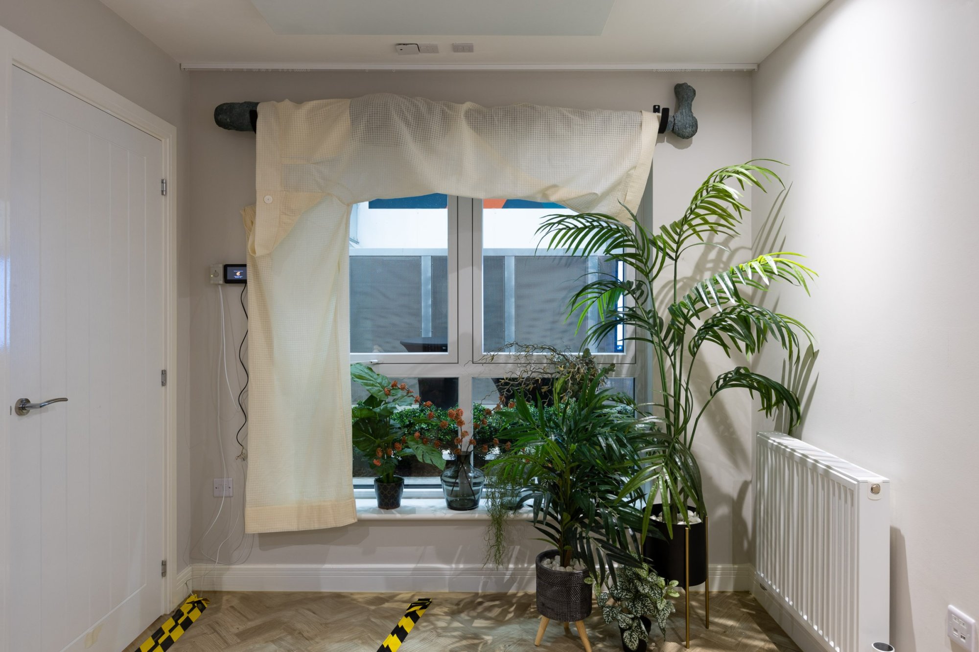'Wearing the Trousers' plaster curtain rod and sheer trouser curtains.