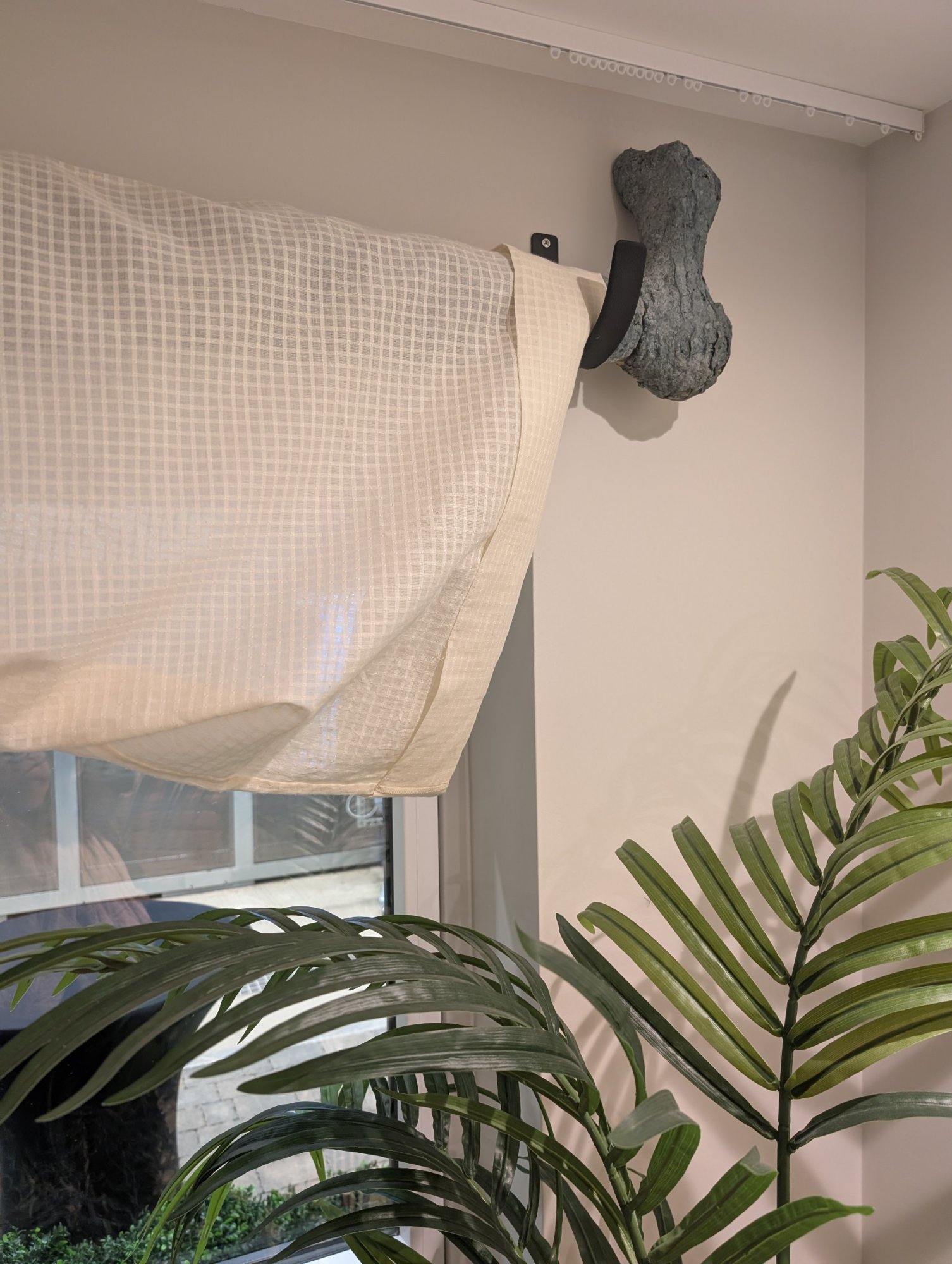 'Wearing the Trousers' plaster curtain rod with sheer trouser curtains.